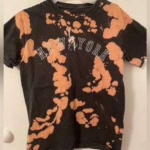Orange and black T-shirt from FASHION NOVA